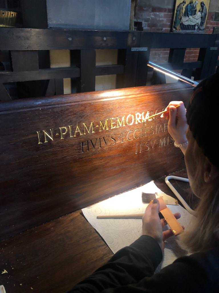 Letter gilding in progress